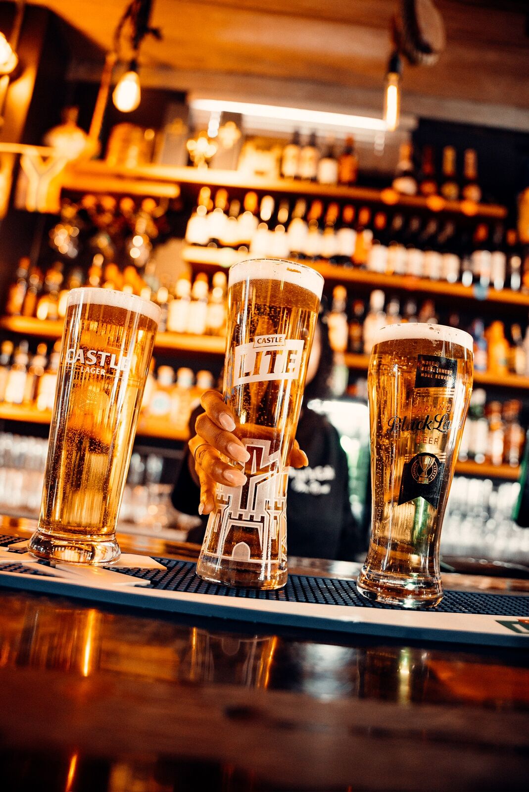 Cold draught beers lined up on the bar at Captain's Cabin, Saldanha