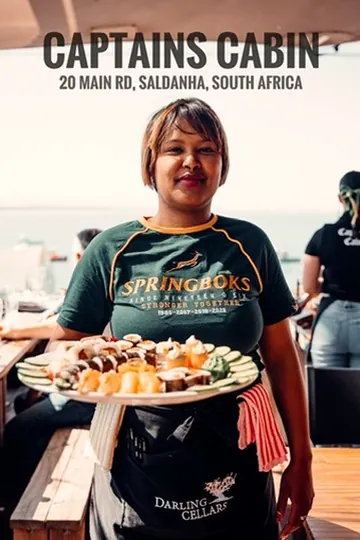 Captain's Cabin server holding a platter of fresh sushi